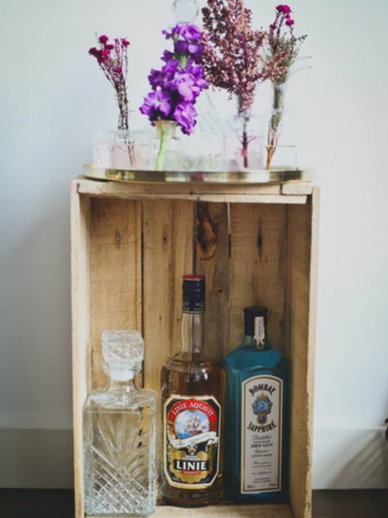 barzinho rústico em caixote, com bebidas dentro e plantas em cima