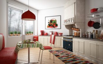 A foto mostra um exemplo de cozinha retrô em tons de vermelho e bege. Há um armário com puxadores redondos e uma bancada com os utensílios à mostra. Tem também uma mesa com banco.