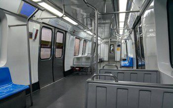 Foto que ilustra matéria sobre linha de metrô RJ mostra o interior do MetrôRio com bancos vazios de cor azul e cinza.