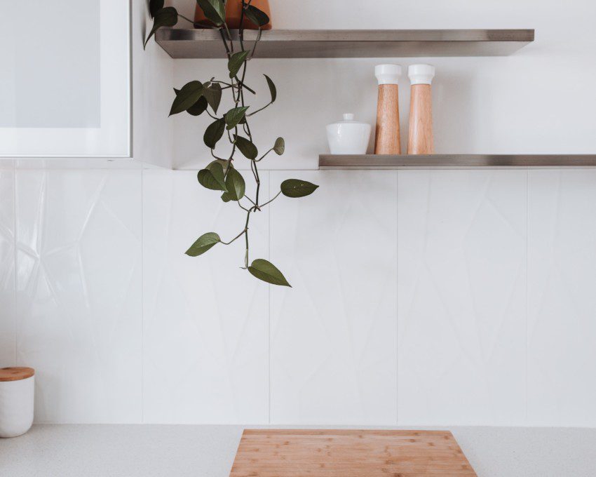 Imagem de duas prateleiras suspensas decorada com um vaso de planta pendente.