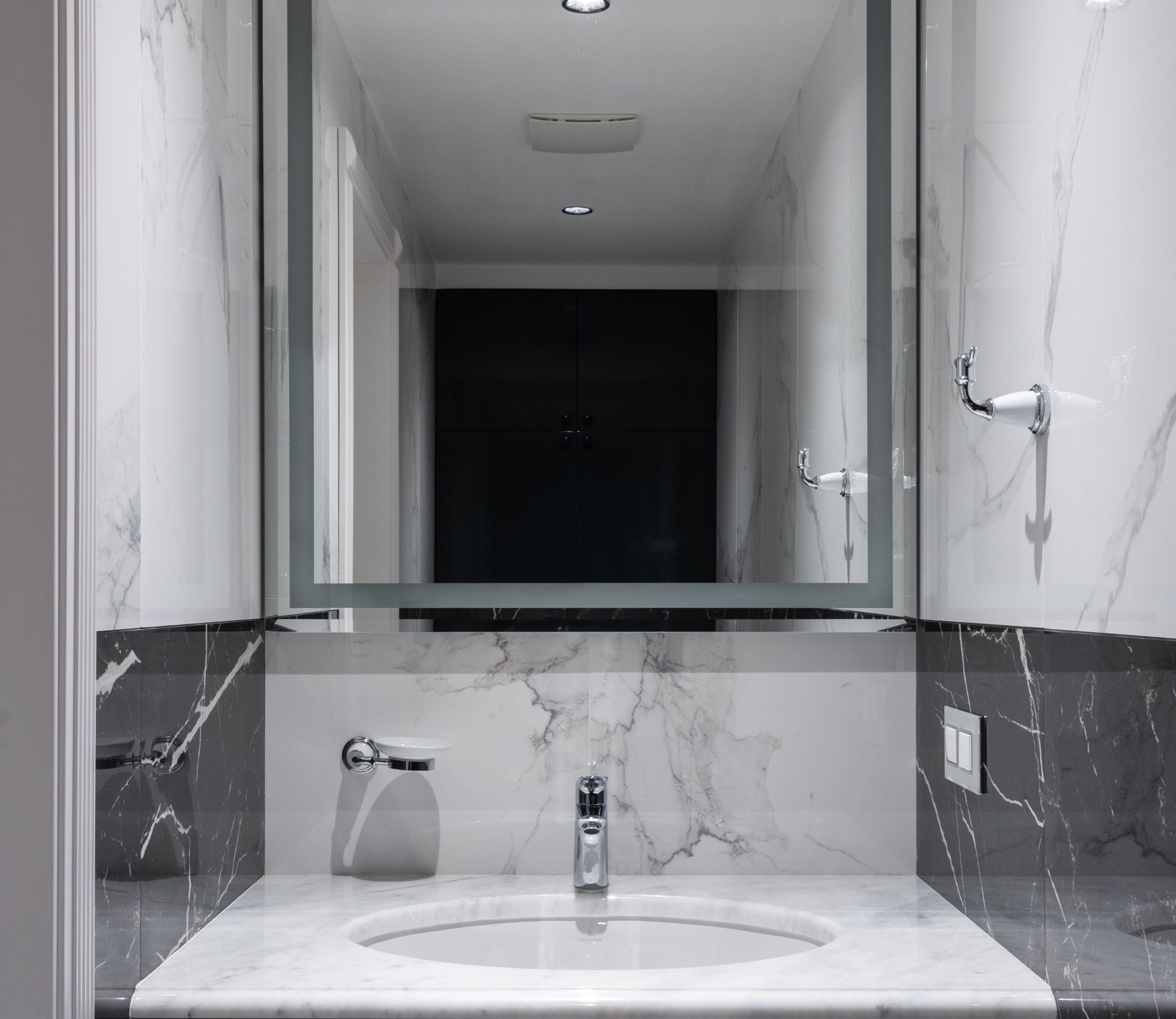 Um banheiro com revestimento de mármore em tons neutros tem seu charme.
