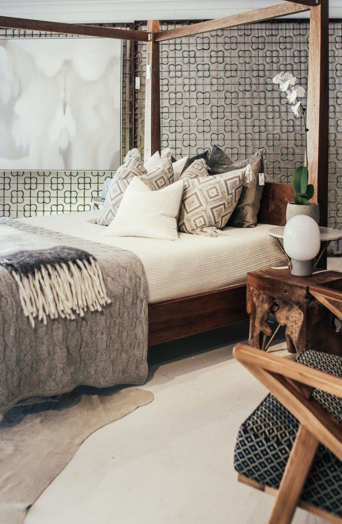Exemplo de disposição de travesseiros e almofadas em quarto decorado com tonalidades de cinza.