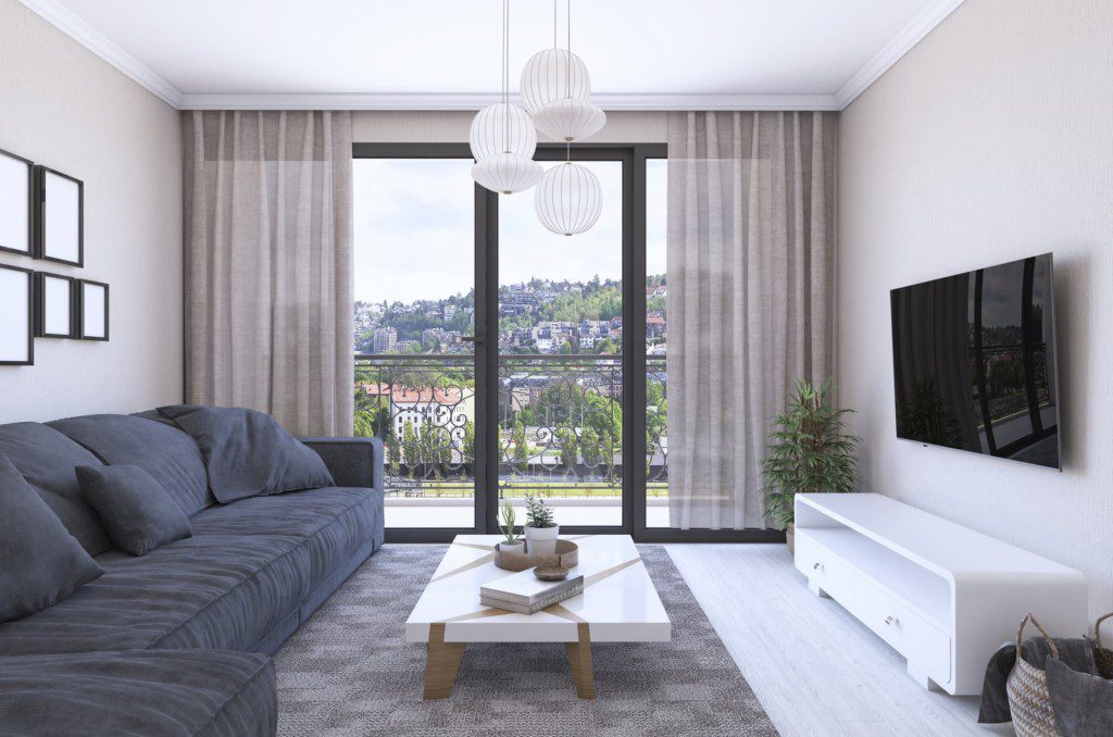 Sala de estar com moldura de gesso no estilo reto frisado. Imagem disponível em Getty Images.