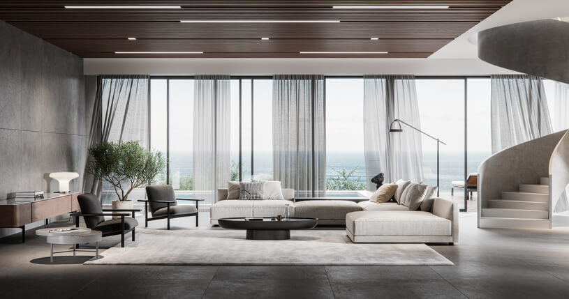 Foto que ilustra matéria sobre estilo contemporâneo mostra uma ampla sala de estar com sofá em L, poltronas e uma mesa de centro. Atrás, grandes janelas que vão do chão ao teto.