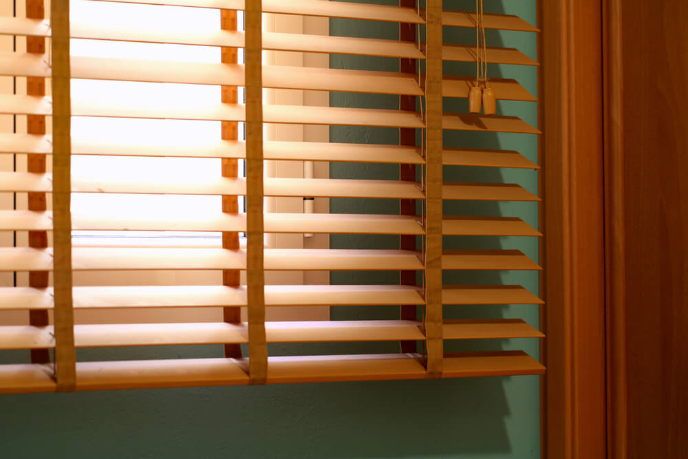 Foto que ilustra matéria sobre tipos de cortina mostra o detalhe de uma persiana.