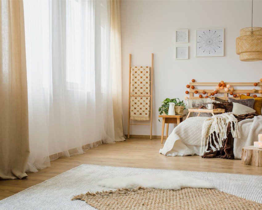 Exemplo de quarto com decoração com sobreposição de tapetes.