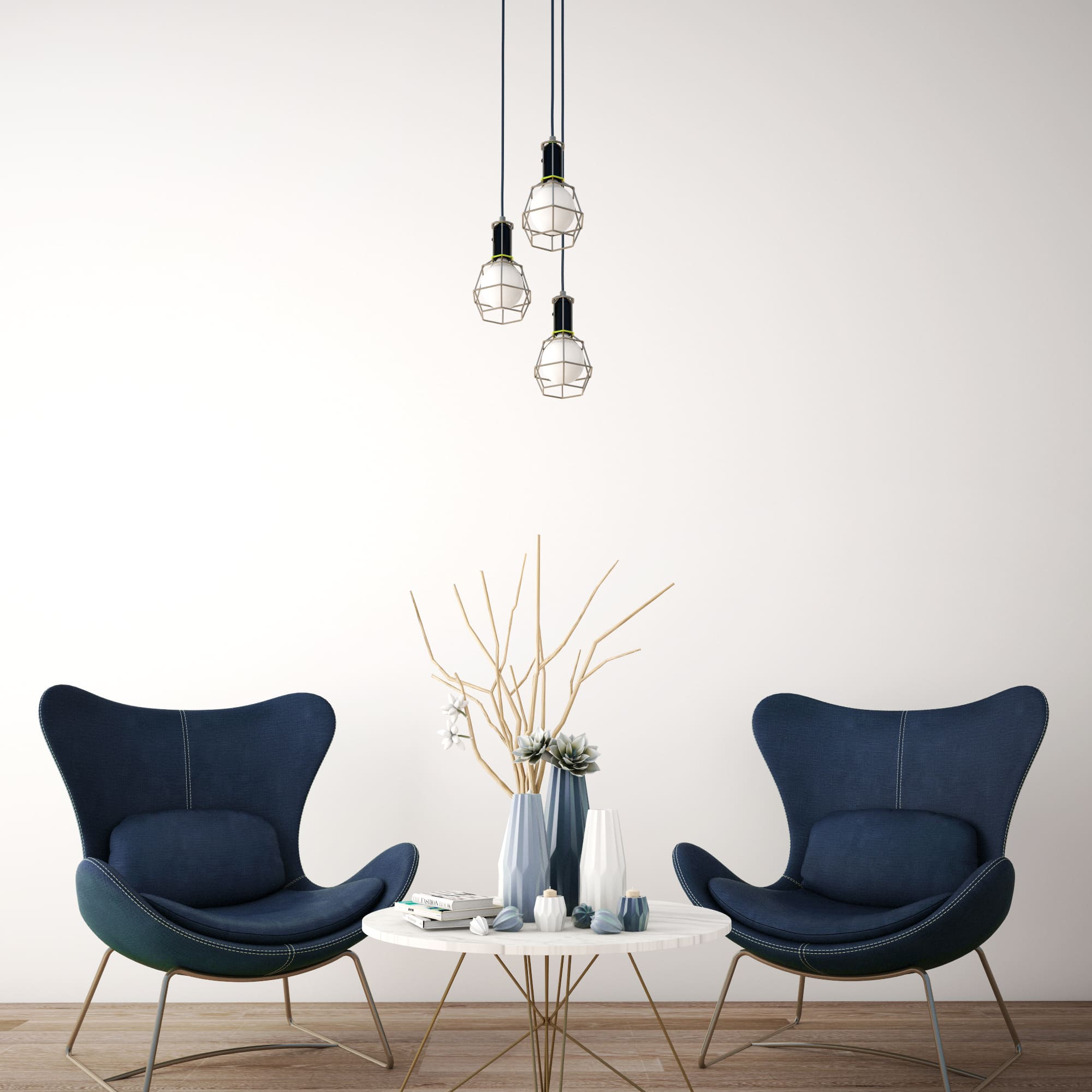 Imagem de duas poltronas na cor azul escuro, com mesa de apoio no meio delas e uma luminária de teto minimalista. 