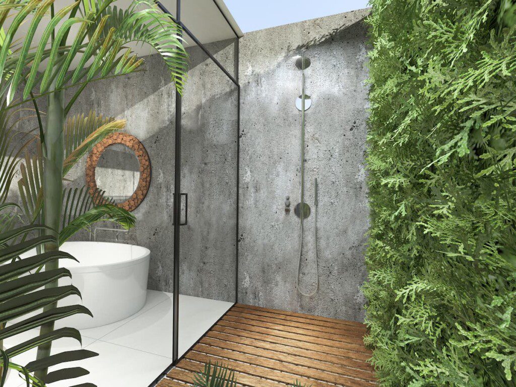 Banheiro em casa de luxo, com revestimentos naturais. É possível ver paredes cruas, sem revestimento, plantas e madeira no piso.