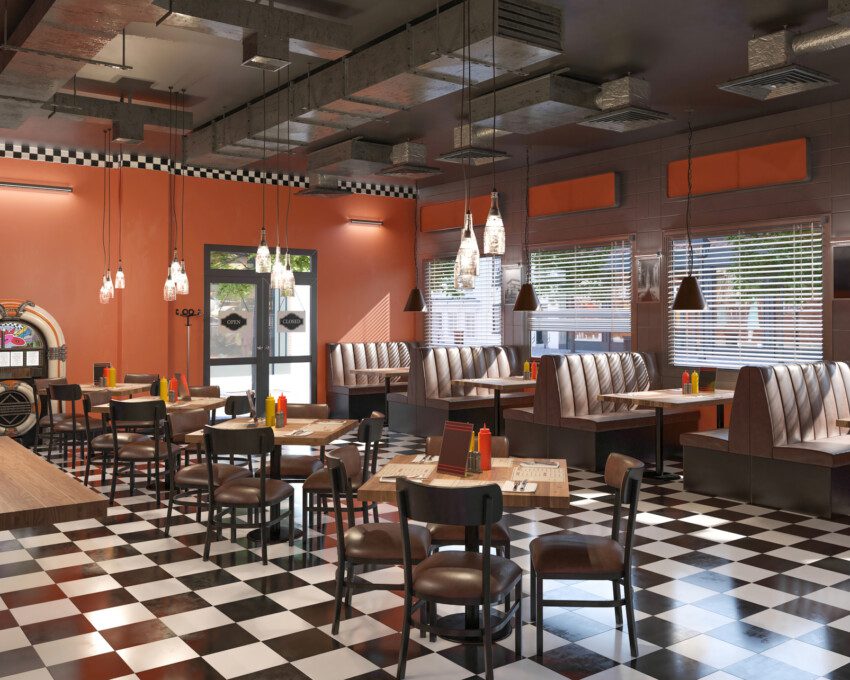 Imagem panorâmica de uma hamburgueria típica dos Estados Unidos com piso quadriculado preto e branco e teto industrial com lustres para ilustrar matéria sobre restaurantes temáticos em SP