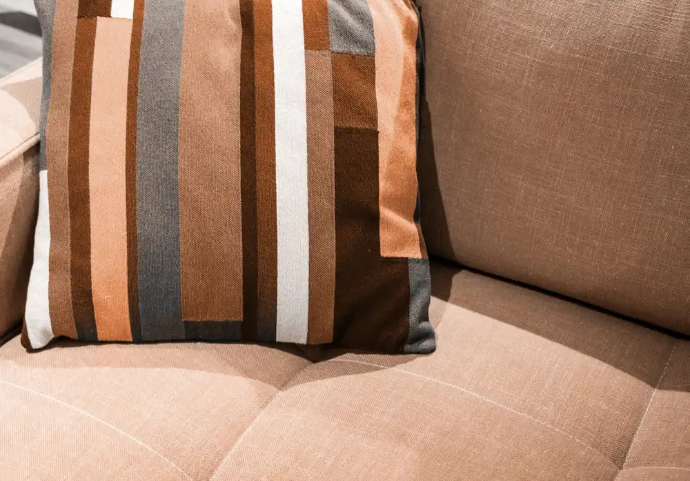 The image that illustrates the article about the color of the year 2024 shows a pillow detailed in the color Peach Fuzz (Image: Shutterstock)